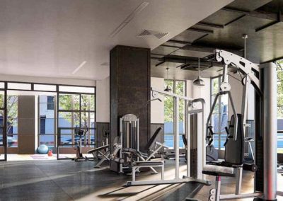 Spacious indoor fitness center with various workout equipment a lots of windows for an outdoor view.