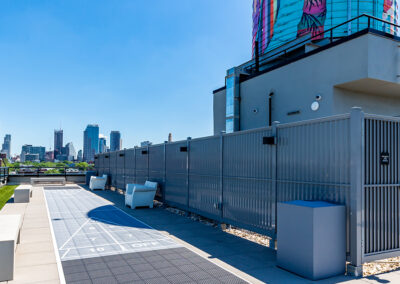 Apartments in Brooklyn rooftop pool area with city views of Brooklyn and space for seating and activities.