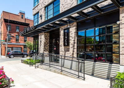 Exterior of 363 Bond with sidewalk and blossoming plants.